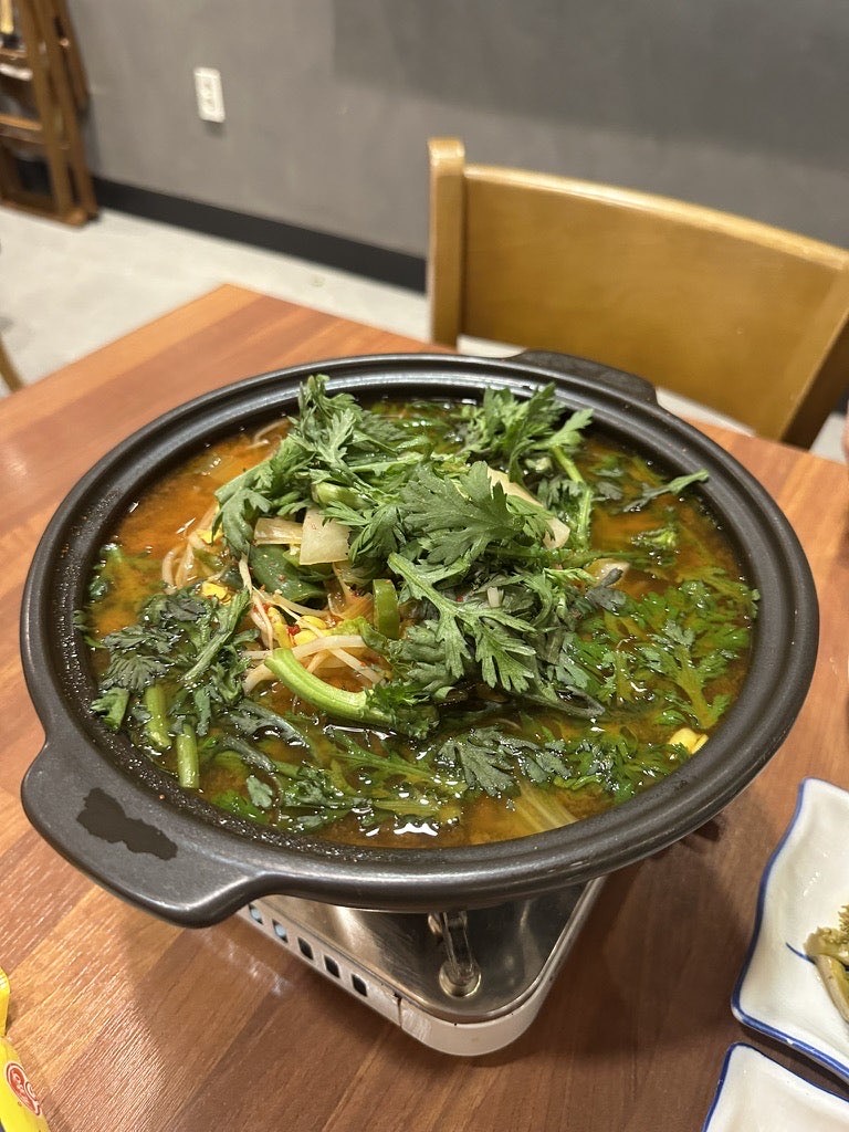Maeuntang, a spicy fish stew topped with greens, at Namttori in Aewol